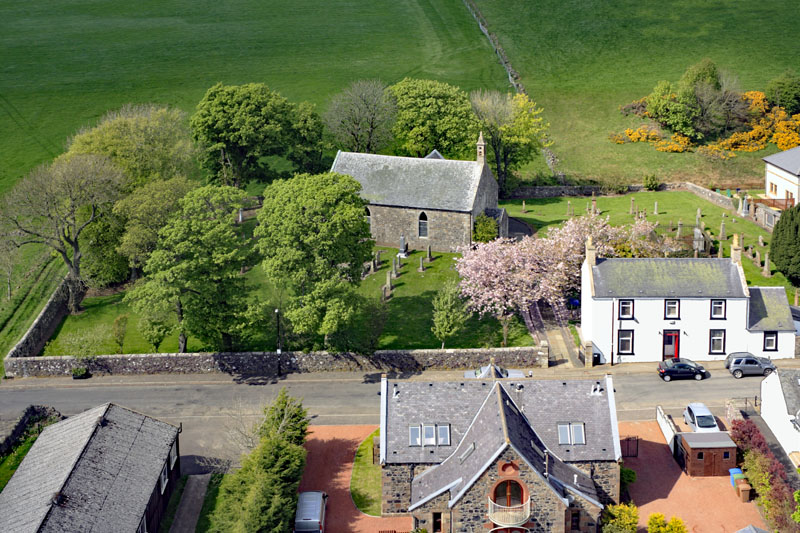An aerial view of Craigie Village and Church, by Kilmarnock, Ayrshire